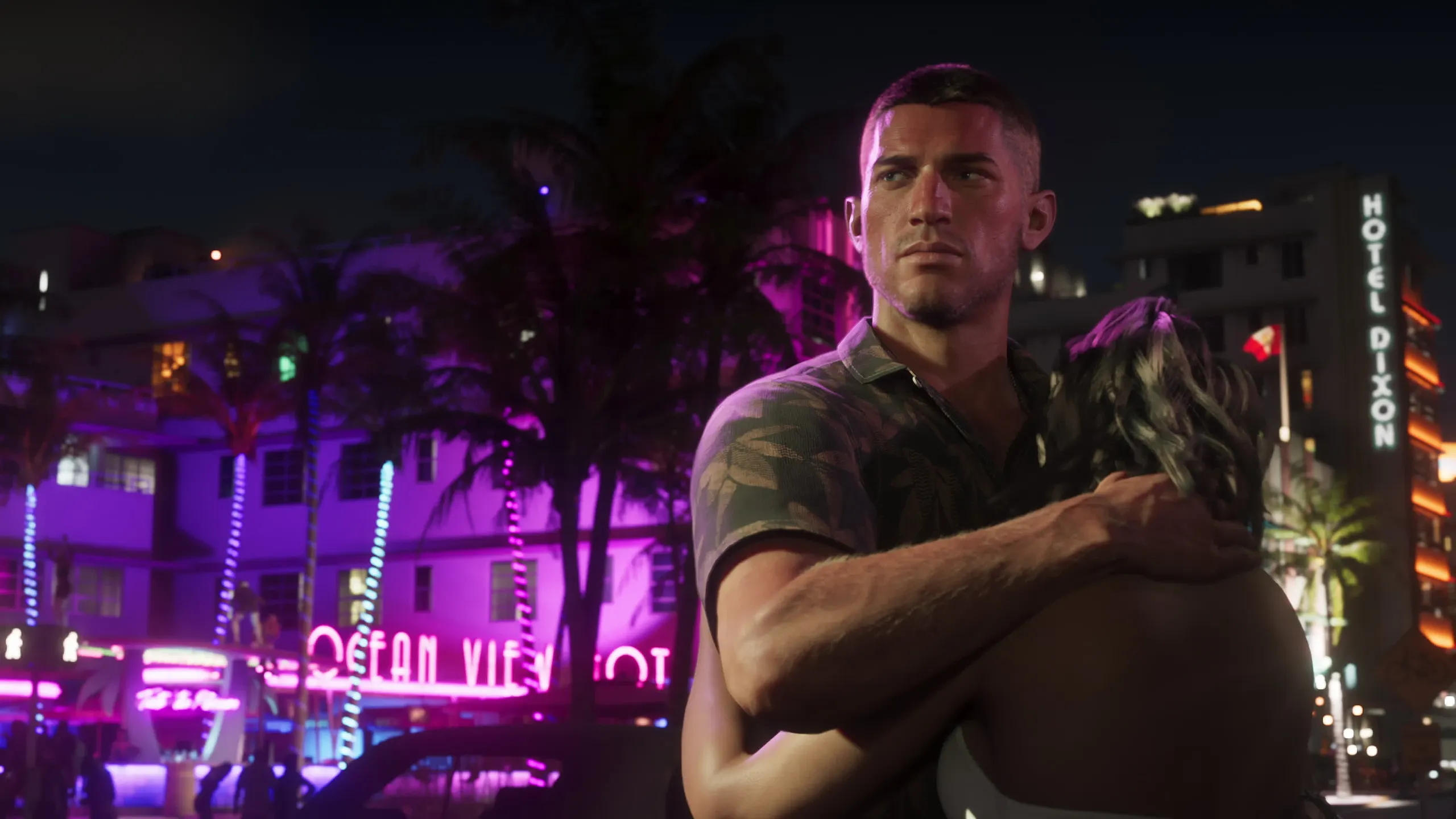 Jason and Lucia embrace on Ocean Drive at night